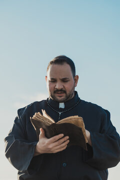 Monk Flipping The Pages Of The Bible Outdoor 