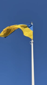 Ukrainian Flag Fluttering in Wind on Sunny Day