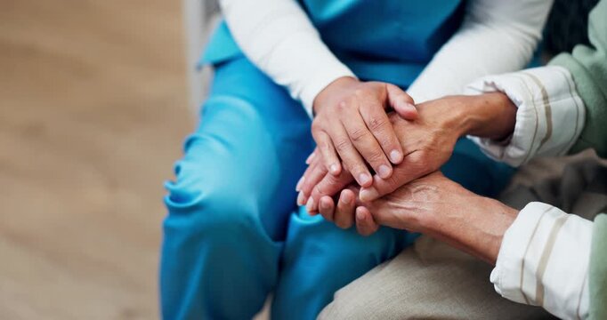 Caregiver, above and holding hands with senior woman for empathy, compassion and emotional support. Nursing home, comforting and nurse with elderly person for sympathy, wellness and care for bonding