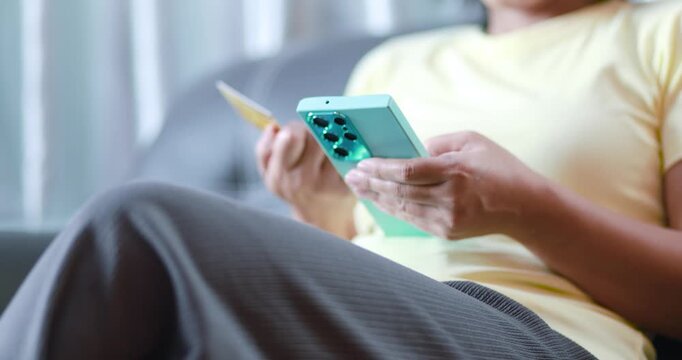 Hands holding a smartphone and credit card, online payment, mobile banking, e-commerce, digital finance, secure transactions, cashless shopping, and fintech, close-up