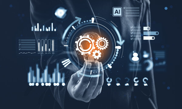 Business hand holding illuminated cogwheel interface with futuristic data elements and technology drawings on dark background for innovation concept.