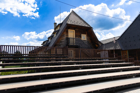 Serbia Mokra Gora 26.05.2026 Rustic Wooden House Behind Empty Outdoor Bleachers