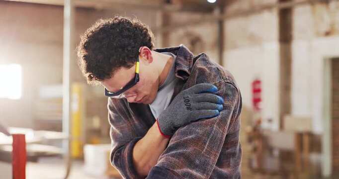 Carpentry, shoulder pain or man in warehouse with massage, muscle issue or fatigue in building project. Accident, overworked or carpenter with discomfort, arm strain or labor injury in woodworking.