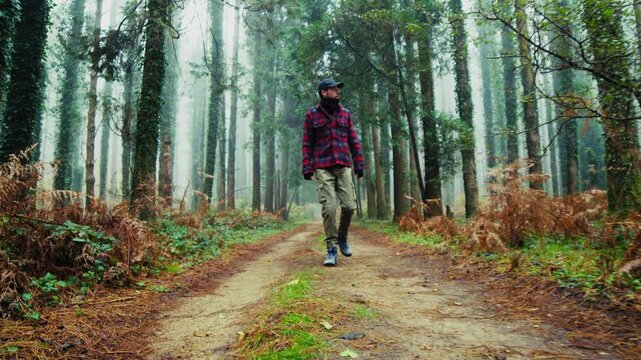 lonely man walking in foggy forest