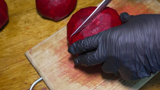 Fresh beet slicing, chef preparing organic vegetables for salad. Overhead top-down shot.