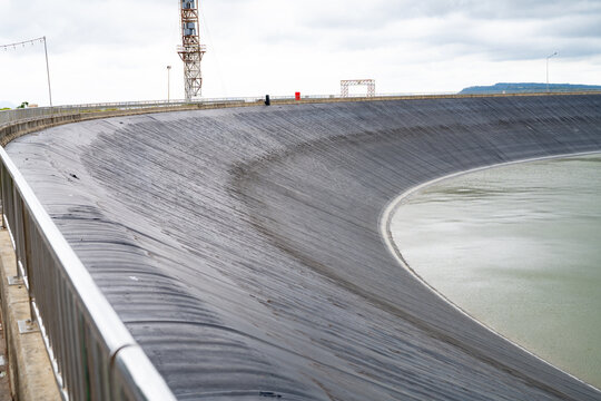 HDPE plastic lined water reservoirs and landscape of wind farm for power generating stations. High density polyethylene engineering material. Wind power. Sustainable, renewable energy. Windmill farm.