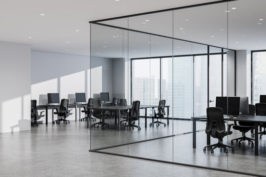 Modern open-plan corporate office interior featuring glass-partitioned meeting space, sleek workstations, panoramic city skyline views and minimalist design. 3D Rendering
