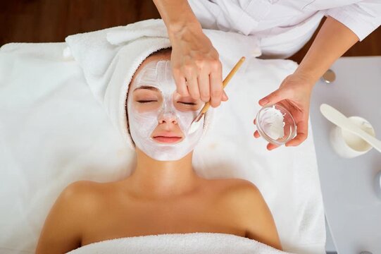 Woman in mask on face in spa beauty salon.	
