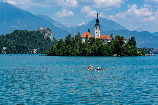 Slovenia, boats on the Lake Bled with in the background the castle and island with church