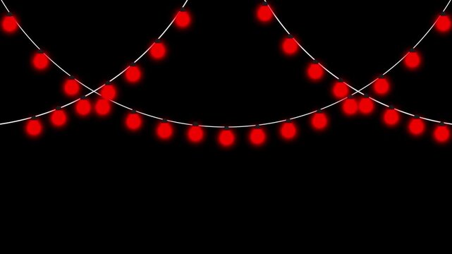 Red string lights hanging against a black background