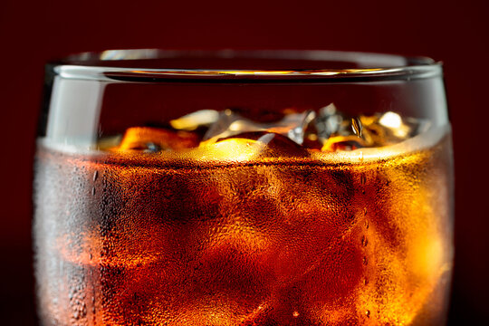 Fizz sparkling cola bubbly soda pop with ice cubes.