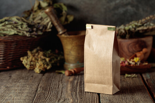 Tall brown paper bag on an old wooden table.