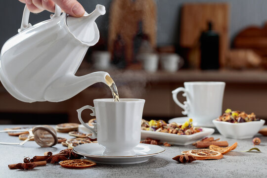 Herbal tea is poured into a cup.