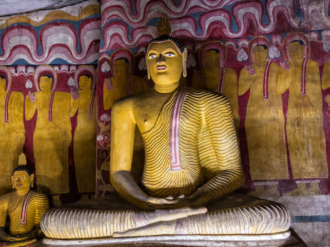 Golden Buddha Statue Inside a Historic Sri Lankan Cave Temple with Ancient Frescoes