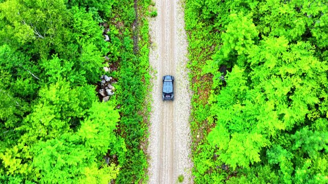 Drone Tracking Side by Side on a remote dirt road on a summer afternoon 