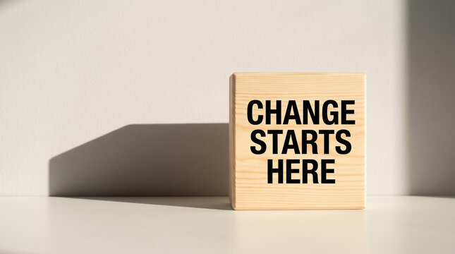 Wooden block displaying change starts here message, symbolizing new beginnings, motivation, and improvements