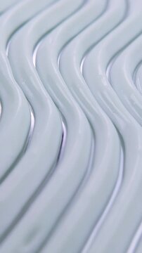 Close up of beauty cream featuring a zigzag pattern. Short video process of creating the pattern for product presentation. Artistic skincare texture concept.
