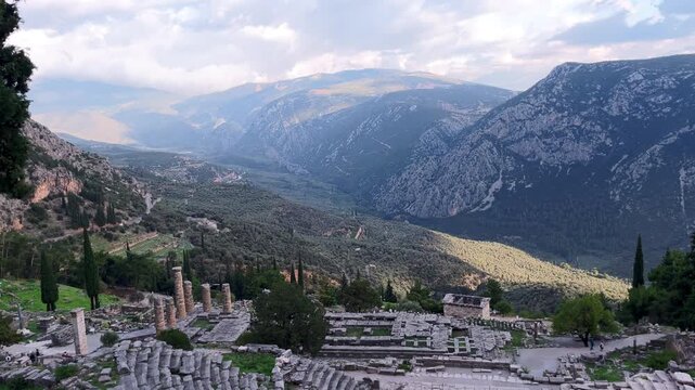 Tilt down from Valley of Phocis revealing the Sanctuary and Theatre of Delphi, Greece