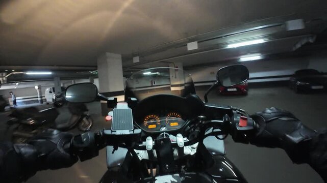 Motorbike rider pov navigating underground parking garage