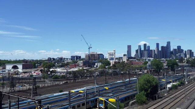 Aerial view of Melbourne rail yard with city skyline in the distance