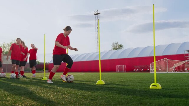 Womens soccer training session with agility dribbling drills, teamwork practice, and dynamic footwork exercises on an outdoor artificial turf field