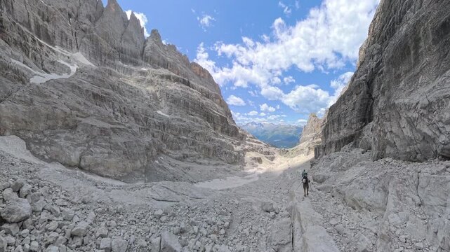 Two hikers descending from Bocca di Tuckett on Via Ferrata Bocchette Alte in the Brenta Dolomites