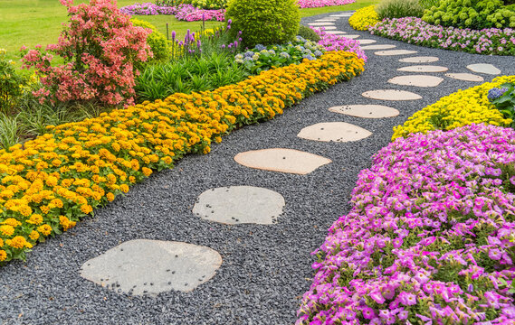 Walkway in flower garden in summer time. Colourful Flowerbeds in a good care maintenance landscapes and walkway