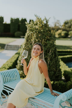 Celebrating joy in a beautiful garden with a glass of sparkling drink