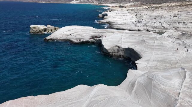 Aerial view of Sarakiniko volcanic white rocks and beach in Milos island, Greece
