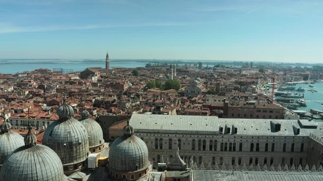 Majestic St Marks Basilica domes and terracotta rooftops overlook the blue Venetian lagoon. A breathtaking panorama inspiring luxury European travel and romantic vacation escapes.