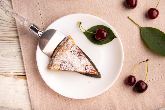 Slice of Cherry Pie Served on Plate with Fresh Cherries