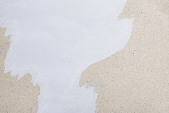 Natural recycled paper texture with white paint overlay and subtle rough surface. Minimal eco-friendly abstract background with copy space for branding and design.