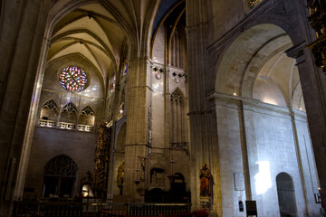 Fototapeta premium A gothic nave leads toward a stained glass rose window inside Oviedo Cathedral Spain 