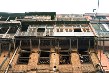 Fototapeta premium Centuries-old traditional Newari houses in Bhaktapur, Nepal, featuring beautifully preserved brick facades, carved wooden windows, and timeless architecture in one of the country's oldest city