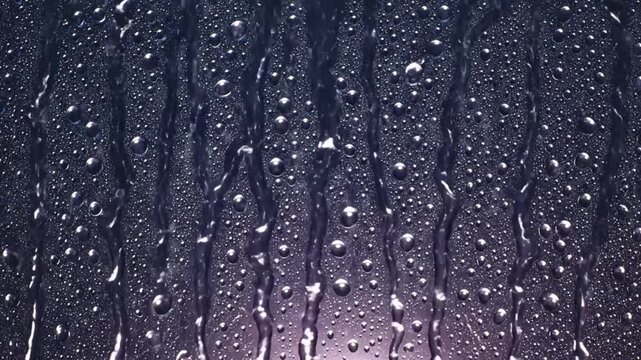 Raindrops cascading down a glass surface with bubbles and streaks of water creating a refreshing aesthetic