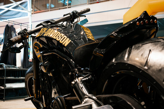 Low-angle view of a custom Harley-Davidson motorcycle featuring clip-on handlebars, racing slick rear tire, solo seat, and aerodynamic tail section.