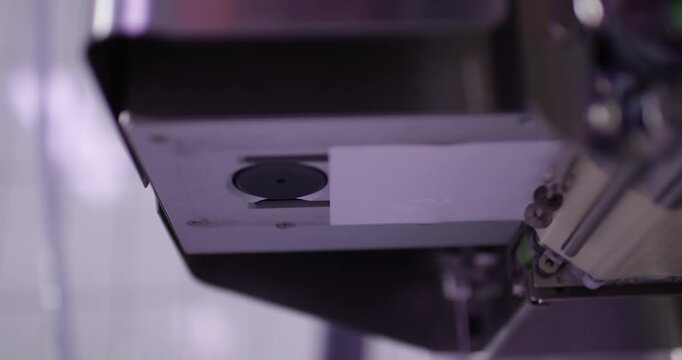 Labeling machine dispensing printed label on packaging line