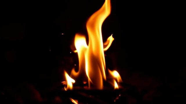 Dynamic fire flames burning in dark nighttime background