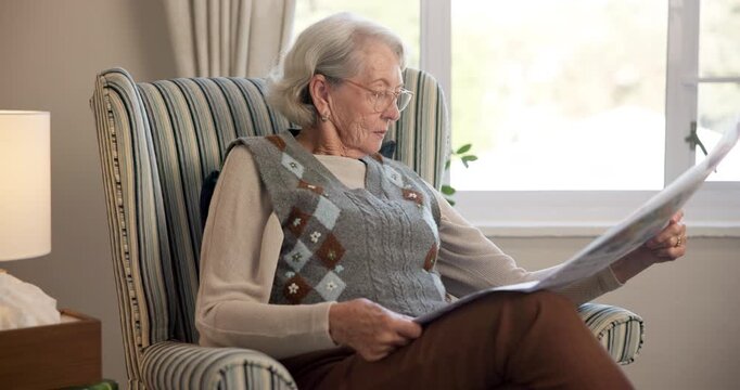Newspaper, reading and retirement with old woman in living room of home for break or information. Article, glasses and relax with senior person on chair in apartment for media publication or report