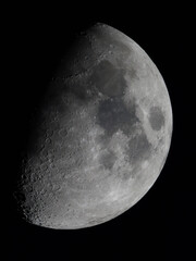A detailed image of a half-illuminated moon in space. © Daan Klein