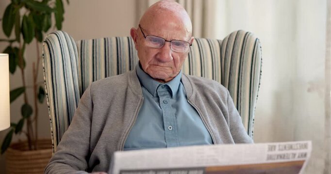 Glasses, newspaper and relax with old man in living room of home for break or information. Article, reading and retirement with elderly person on chair in apartment for media publication or report