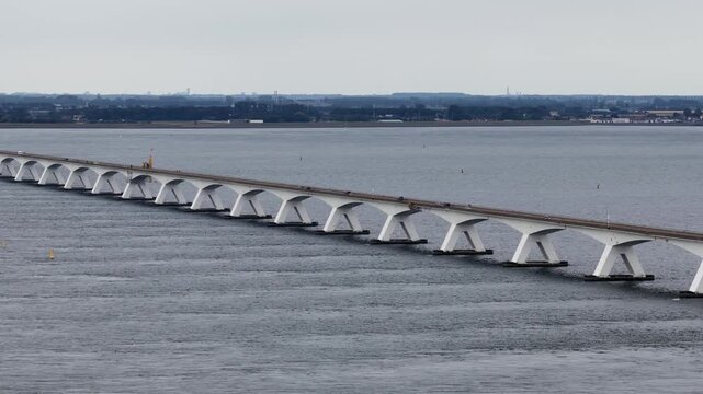 Cars crossing the zeeland bridge over the sea