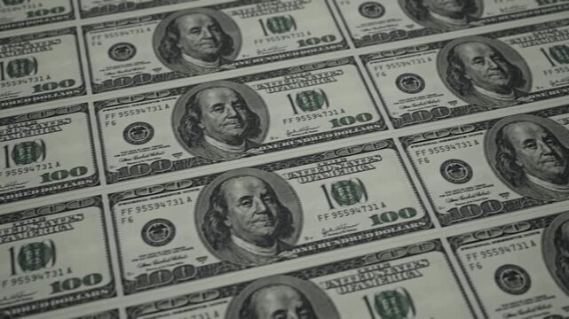 CGI of $100 bills in a tiled pattern. Camera glides over banknotes showing engraving and security details. Ideal for finance and wealth content. Rendered in Unreal Engine.
