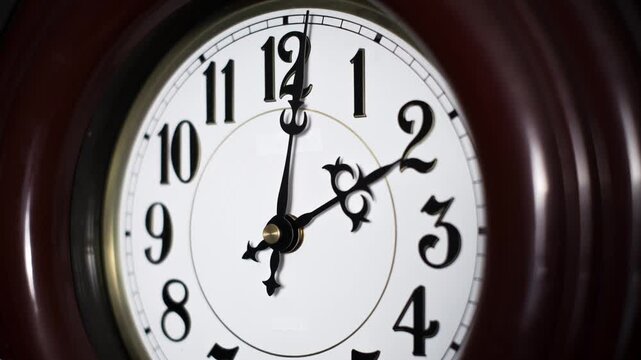 A time-lapse view of a classic analog wall clock face with black numerals and hands spinning rapidly. Concept of deadline pressure, fleeting moments, business urgency, and rapid time flow.