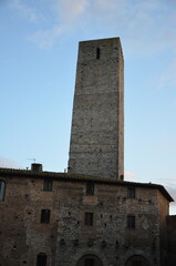 Obraz premium San Gimignano, Italy 03.04.2020: Town Hall (also known as the Palazzo del Popolo or Palazzo Nuovo del Podestà) and the Torre Grossa in San Gimignano