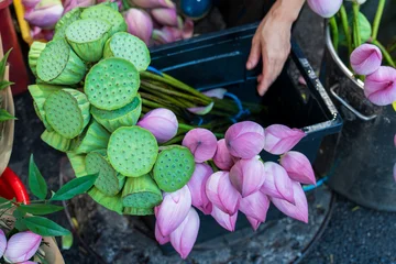 Close up of lotus flowers and seed pods prepared for sale at a traditional market  © imphilip