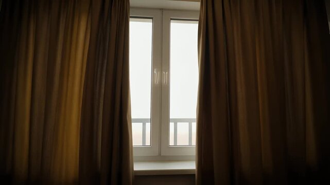 Window framed with two heavy curtains barely moving, soft ambient light behind