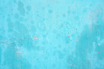 Abstract textured blue wall with weathered paint spots © ornax photo