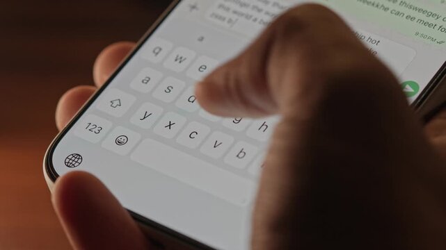 Man hands chatting and typing on smartphone macro closeup. Unrecognizable human typing text message tapping touchscreen keyboard using whatsapp application a social media