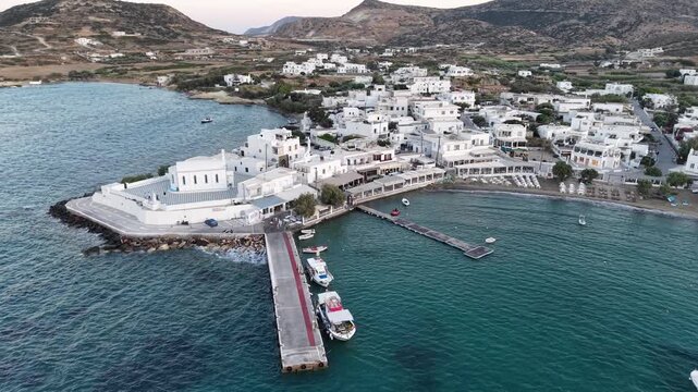 Aerial view of Pollonia village and Agia Paraskevi church at sunset, Milos Island, Greece